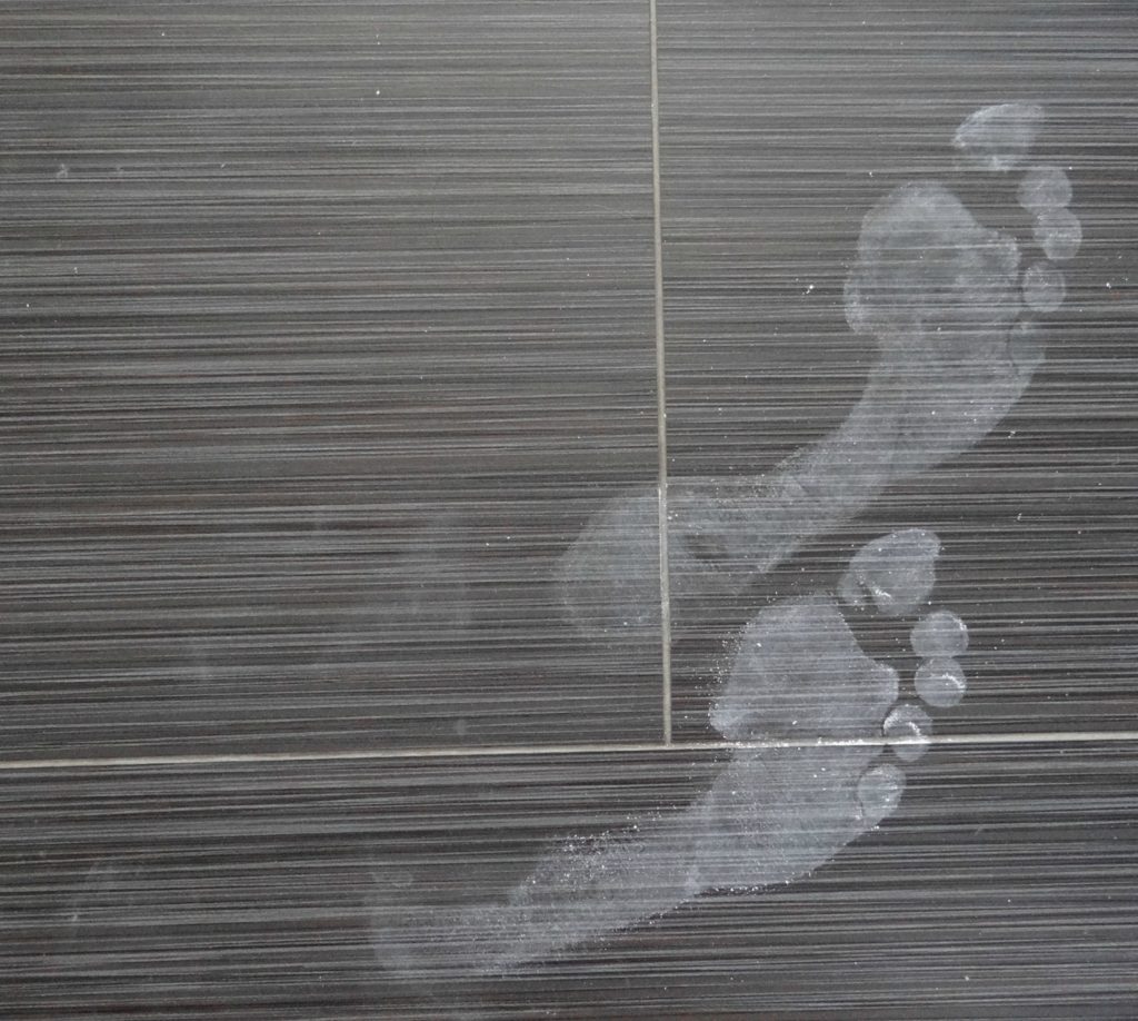 footprints-on-tile-floor