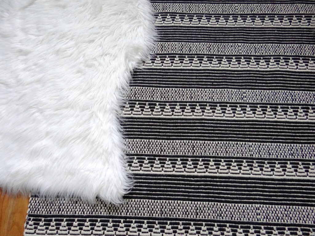 Black and white rug with fur rug